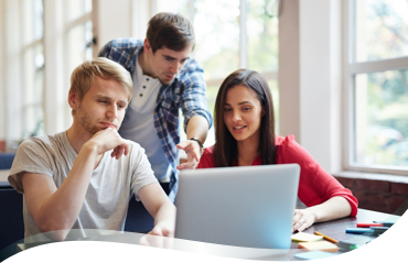 3 collaborateurs devant un ordinateur brainstorment
